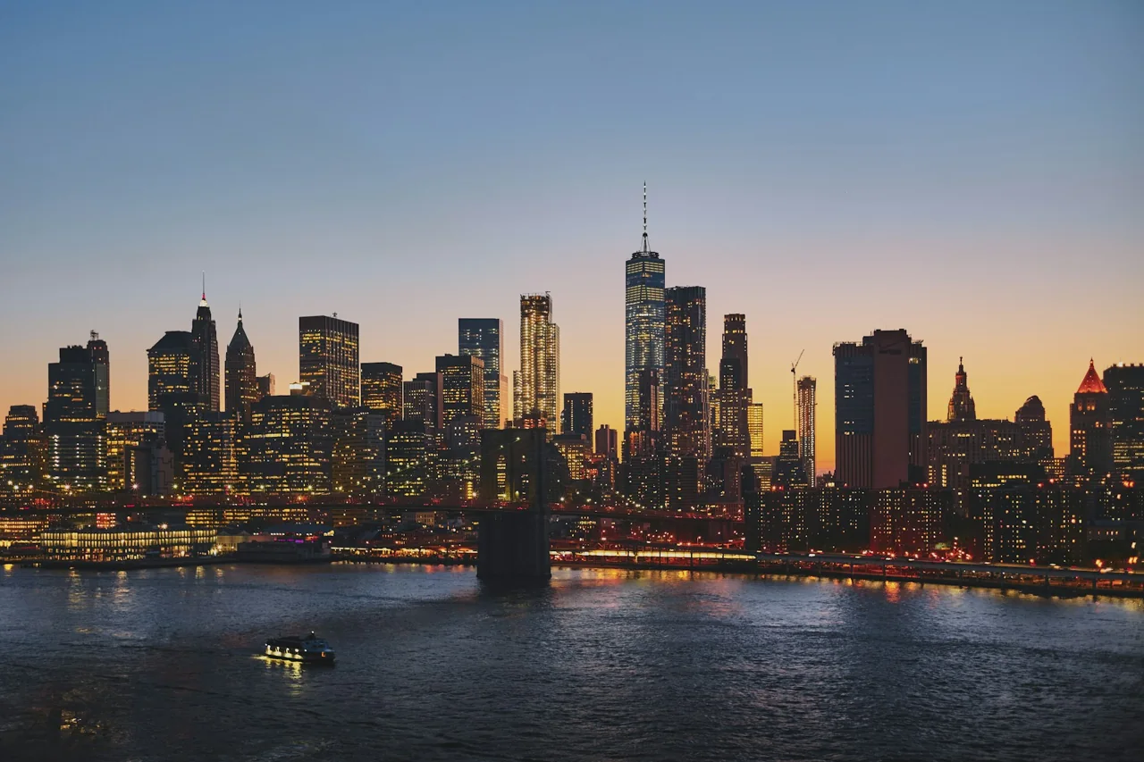 Brooklyn Bridge, with Manhattan in the distance at golden hour.